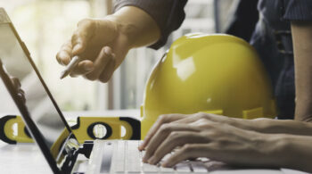 Architect engineer working concept and construction tools or safety equipment on table.